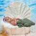 Baby in a shell shaped crib.